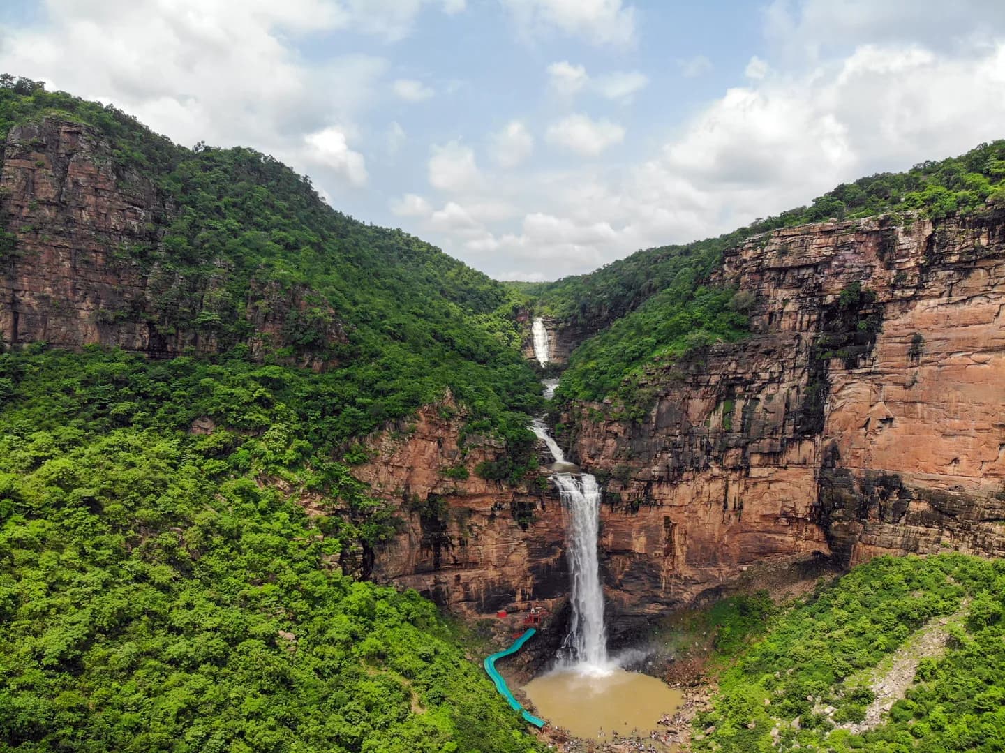 Tutla Bhawani waterfall surrounded by rocky cliffs in Rohtas